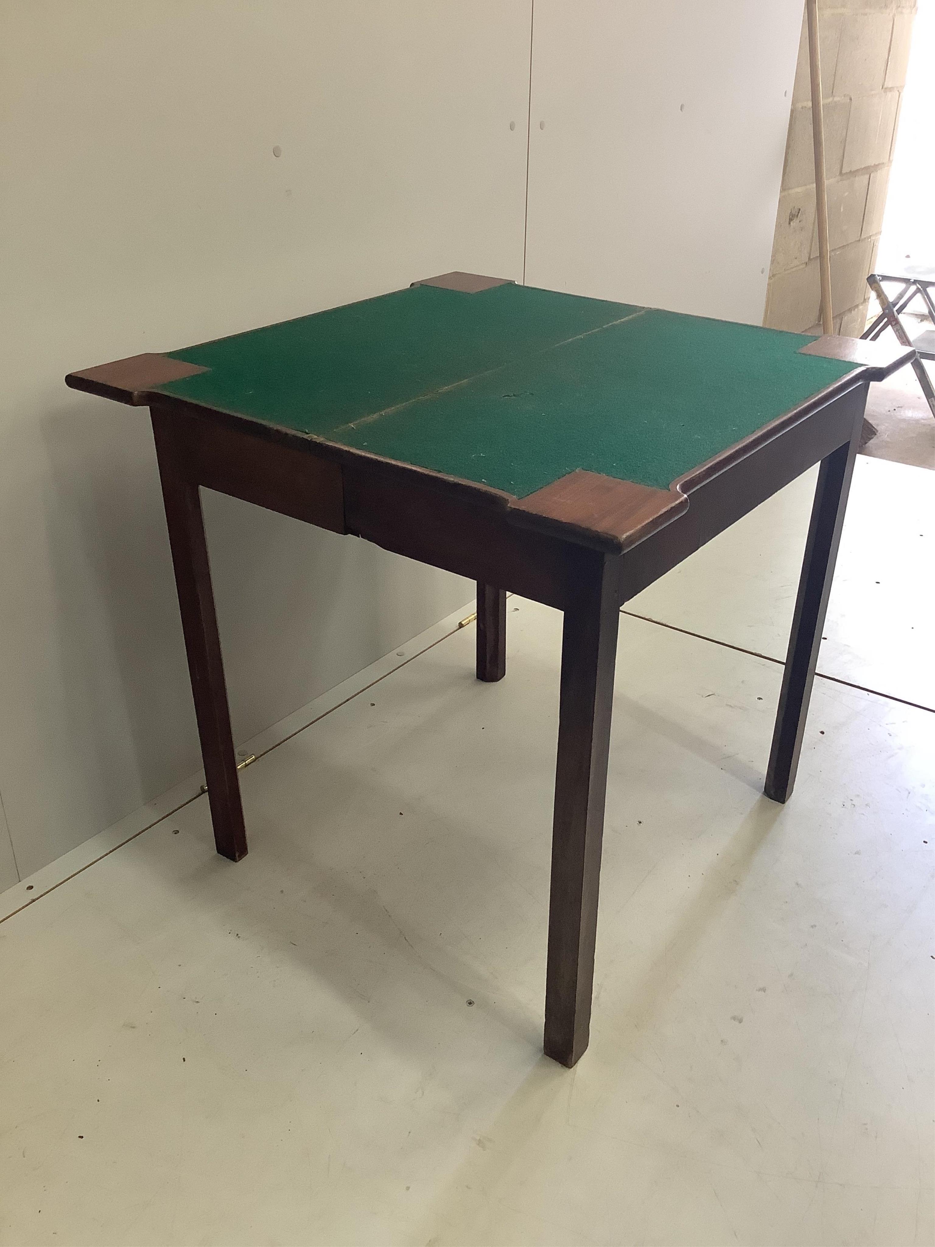 A George III mahogany folding card table, width 74cm, depth 37cm, height 73cm. Condition - fair